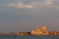 Basilica di Santa Maria della Salute at orange colors reflected on the water surface, Venice, Italy Royalty Free Stock Photo