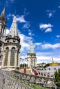 Basilica of our Lady of the Rosary and flags of different countries against the sky. Lourdes, France, Hautes Pyrenees Royalty Free Stock Photo