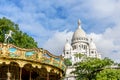 Basilica Sacre Coeur in Montmartre with carousel in Paris, France