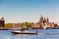 The Basilica of Saint Nicholas Sint-Nicolaasbasiliek, skyline and river with boats and ships during summer sunny day in Amsterdam Royalty Free Stock Photo