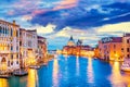 Basilica Santa Maria della Salute, Punta della Dogona and Grand Canal at blue hour sunset in Venice, Italy with boats and Royalty Free Stock Photo