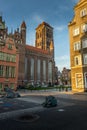 Basilica of St Mary in the old street with nearby buildings in Gdansk, Poland