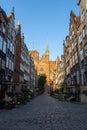 Basilica of St Mary in the old street with nearby buildings in Gdansk, Poland
