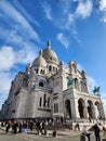 The Basilique du SacrÃ© Coeur sits atop La butte Montmartre, the sacred heart of Paris. It is a white marble church.