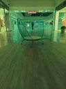 Basilix shopping mall. Unusual bench design in the form of a metal basket. The man in black clothes is in the center of the photo. Royalty Free Stock Photo