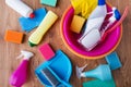 Basin with cleaning stuff on wooden floor Royalty Free Stock Photo