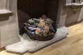 Basin with multi-colored pillow by the fireplace as home decoration