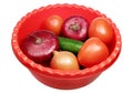 Basin with vegetables on a white background