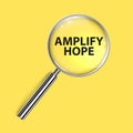 amplify hope under magnifier glass on yellow Royalty Free Stock Photo