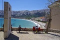 People rest on benches in Baska town on Krk Island on April 30, 2017. Croatia