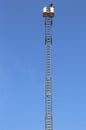 Basket with aerial platform over the very long ladder and blue Royalty Free Stock Photo