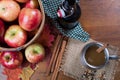 Basket of apples with cup and bottle of apple cider top view