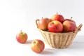 A basket of apples on a white wooden table. Copy space