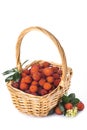 Basket with arbutus unedo fruits over white