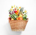Basket with assortment of fresh organic fruits and vegetables on white background, top view Royalty Free Stock Photo