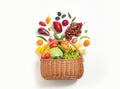 Basket with assortment of fresh organic fruits and vegetables on white background, top view Royalty Free Stock Photo