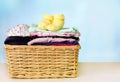 Basket with baby clothes on the table