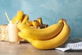 Basket, bananas and juice against background. Fresh fruit