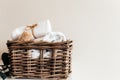 Basket with bathroom accessories. A set of rolled towels. Hotel cleaning concept