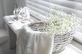 Basket with beautiful flowers and wedding shoes on window sill indoors Royalty Free Stock Photo