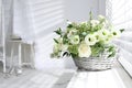 Basket with beautiful wedding flowers on window sill in room Royalty Free Stock Photo