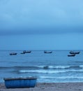 A basket boat on the beach. Basket boat. Basket boat resting on the beach. In the distance are fishing boats near the shore Royalty Free Stock Photo