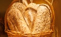 A basket of bread with a few pieces of wheat in it Royalty Free Stock Photo