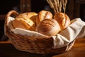 Basket with bread rolls on a wooden table in a bakery, A basket of fresh baked bread in a rustic bakery, AI Generated Royalty Free Stock Photo