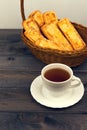 Basket with bread sticks, white porcelain cup