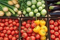 basket brims with organic tomatoes, cucumbers eggplants Supermarket display