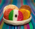 Basket with a bunch of typical mexican coconut candies honey cocada traditional mexican flag carpet background isolated colors