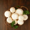 Basket with champignon and greens, top view