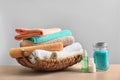 Basket with clean towels, cream and sea Royalty Free Stock Photo