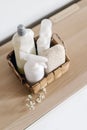 Basket with cleaning supplies on wooden shelf indoors Royalty Free Stock Photo