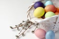 Basket with colorful Easter eggs isolated on white Royalty Free Stock Photo
