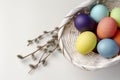 Basket with colorful Easter eggs isolated on white Royalty Free Stock Photo