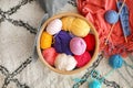 Basket with colorful knitting yarn on floor in room Royalty Free Stock Photo