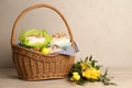 Basket with delicious Easter cakes, dyed eggs and flowers on wooden table Royalty Free Stock Photo