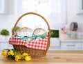 Basket with delicious Easter cakes, painted eggs and flowers on wooden table indoors. Space for text Royalty Free Stock Photo