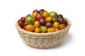 Basket with different color organic tomatoes