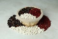 Basket with different types of beans on white textured background Royalty Free Stock Photo
