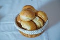 A basket from dough . Sweet buns with poppy seeds in a wicker basket, around rye bread with sesame seeds