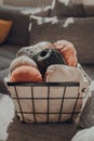 Basket of earth coloured skeins of yarn on a sofa, selective focus Royalty Free Stock Photo