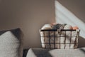 Basket with earth coloured yarn inside an apartment, against a wall, sunlight, selective focus Royalty Free Stock Photo