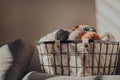 Basket of earth coloured yarn inside an apartment, sunlight, selective focus Royalty Free Stock Photo