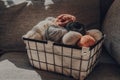 Basket of earth coloured yarn on a sofa, sunlight from the window Royalty Free Stock Photo