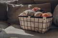 Basket of earth coloured yarn on a sofa, sunlight from the window Royalty Free Stock Photo