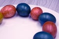 Basket with easter cake and red eggs on rustic wooden table. Top view. Royalty Free Stock Photo