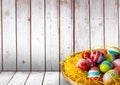 Basket with Easter eggs with wood background Royalty Free Stock Photo