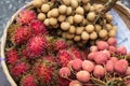 Basket with exotic fruits of rambutan, lychee and longan on Asian market Royalty Free Stock Photo